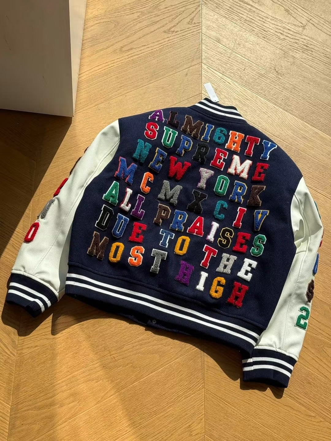 SUPREME PRAISES VARSITY JACKET