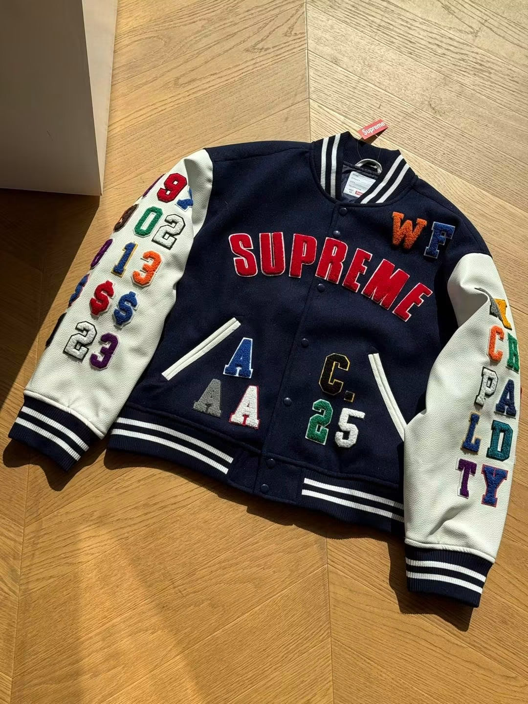 SUPREME PRAISES VARSITY JACKET