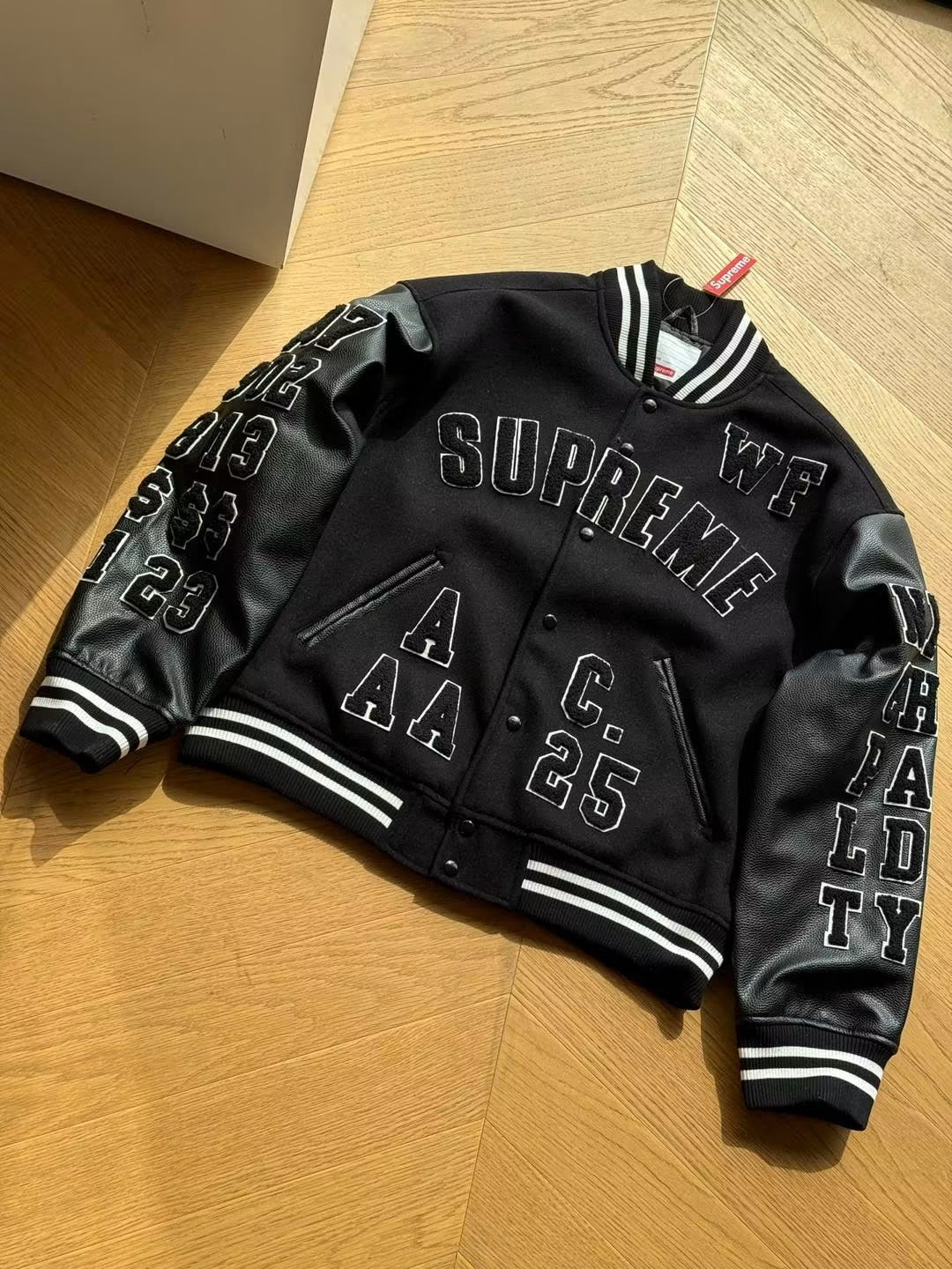 SUPREME PRAISES VARSITY JACKET